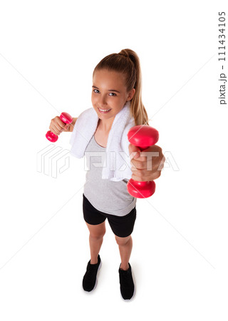 Healthy teen girl with dumbbells working out with towel on shoulder. Isolated on white background. fitness gym concept. Wide angle shot Healthy teen girl with dumbbells working out with towel on shoulder. Isolated on white background. fitness gym concept. Wide angle shot 111434105
