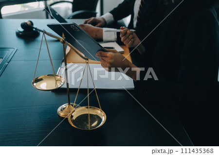 Judge gavel with Justice lawyers having team meeting at law firm background. Concepts of Law and Legal services. Judge gavel with Justice lawyers having team meeting at law firm background. Concepts of Law and Legal services. 111435368