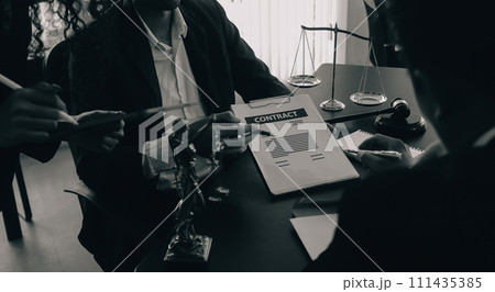 Judge gavel with Justice lawyers having team meeting at law firm background. Concepts of Law and Legal services. 111435385