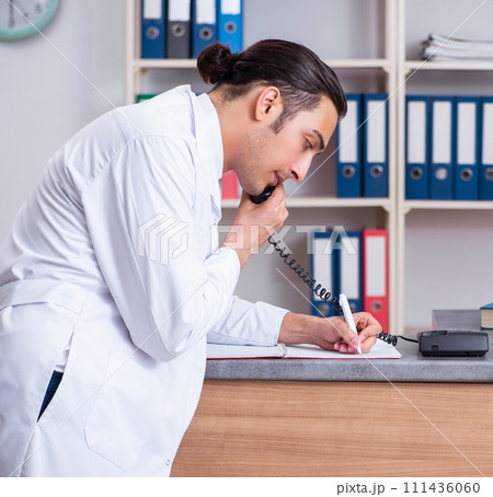 Young male doctor at the reception in the hospital 111436060