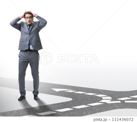 Young businessman at crossroads in uncertainty concept Young businessman at crossroads in uncertainty concept 111436072