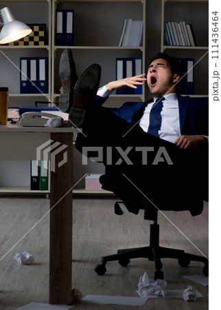 The employee working late to finish important deliverable task 111436464