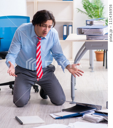 Young male employee unhappy with excessive work 111436956