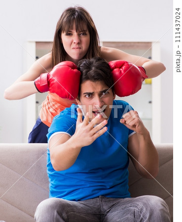 Wife unhappy that husband is watching boxing Wife unhappy that husband is watching boxing 111437024