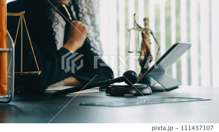 Judge gavel with Justice lawyers having team meeting at law firm background. Concepts of Law and Legal services. 111437107