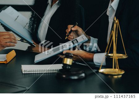 Judge gavel with Justice lawyers having team meeting at law firm background. Concepts of Law and Legal services. 111437165