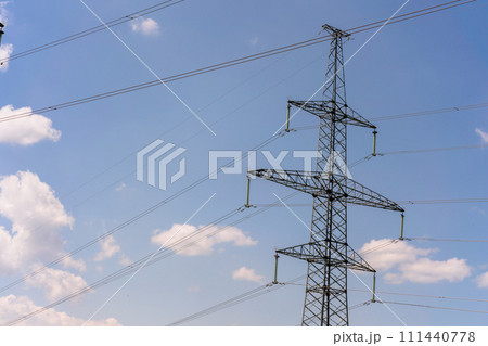 High voltage towers with sky background. Power line support with wires for electricity transmission. High voltage grid tower with wire cable at distribution station. Energy industry, energy saving 111440778