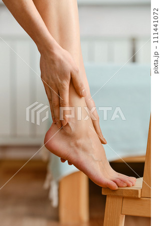 Closeup view of hands massaging foot 111441072