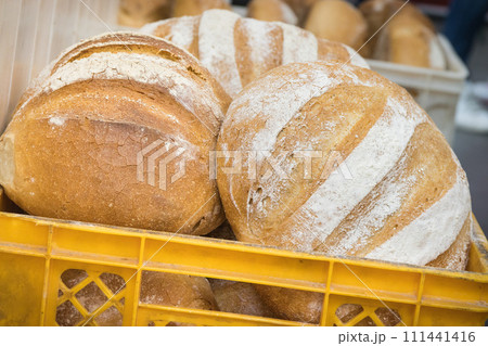 Freshly baked traditional loaves of wheat or rye bread in bakery Freshly baked traditional loaves of wheat or rye bread in bakery 111441416