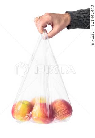 Man hand holding a plastic bag with red apples. 111442443