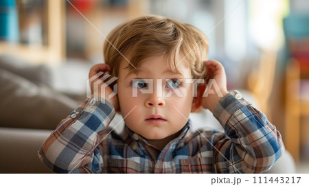 AI-generated content. Little autistic boy closing ears with his hands in a protective position. 111443217