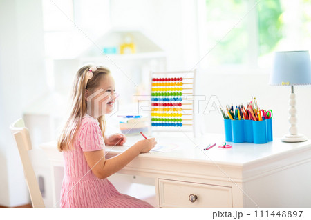 Child drawing. Kids paint. Girl after school. 111448897