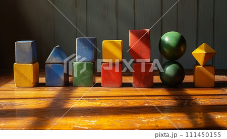Rustic wooden geometric shapes casting shadows on a warm, textured surface. 111450155