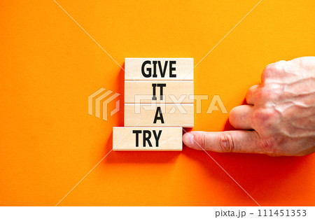 Give it a try symbol. Concept word Give it a try on beautiful wooden block. Beautiful orange table orange background. Businessman hand. Business give it a try concept. Copy space. Give it a try symbol. Concept word Give it a try on beautiful wooden block. Beautiful orange table orange background. Businessman hand. Business give it a try concept. Copy space. 111451353