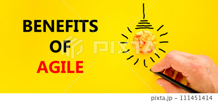 Benefits of agile symbol. Concept words Benefits of agile on beautiful yellow paper. Beautiful yellow background. Light bulb icon. Businessman hand. Business benefits of agile concept. Copy space. Benefits of agile symbol. Concept words Benefits of agile on beautiful yellow paper. Beautiful yellow background. Light bulb icon. Businessman hand. Business benefits of agile concept. Copy space. 111451414