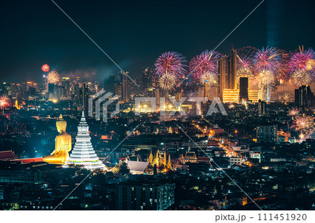 Bangkok night scene with big buddha in temple and firework display show over department store in crowded downtown Bangkok night scene with big buddha in temple and firework display show over department store in crowded downtown 111451920