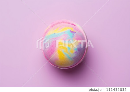 A single colorful bath bomb against purple background. Flat lay, top view A single colorful bath bomb against purple background. Flat lay, top view 111453035