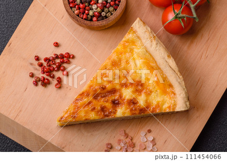 Delicious crispy quiche cut into slices with cheese, broccoli, tomatoes 111454066