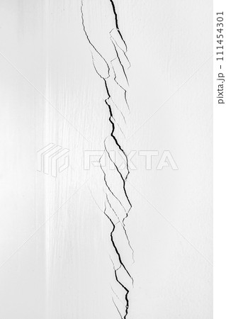 Deep crack in the corner of the room. White wall cracked. Problems of construction and repair. Deep crack in the corner of the room. White wall cracked. Problems of construction and repair. 111454301