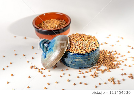 Bowl with raw uncooked buckwheat, Raw Buckwheat Pile, Dry Buck Wheat Grains, Uncooked Buckwheat 111454330