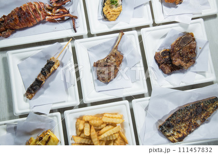 Grilled meat on skewers with french fries on a white plate 111457832