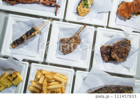 Grilled meat on skewers with french fries on a white plate 111457833