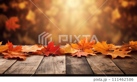 Rustic wooden table adorned with colorful autumn leaves 111462586