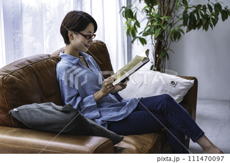 ソファーで読書をするミドルの女性 111470097