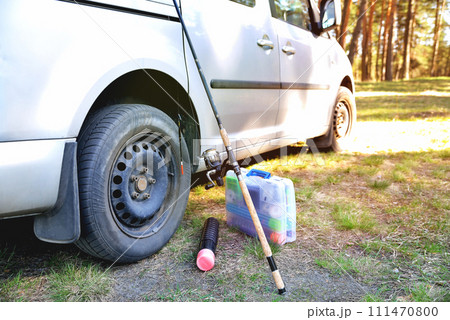 fishing accessories near a car sunny day, sunny tinted glare, preparation for fishing 111470800