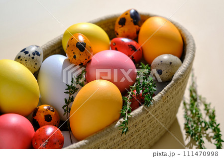 Easter colored eggs in a wicker basket. Easter composition. 111470998