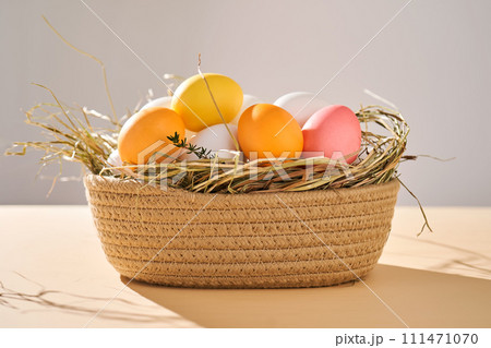 Easter colored eggs in a wicker basket. Easter composition. Easter colored eggs in a wicker basket. Easter composition. 111471070