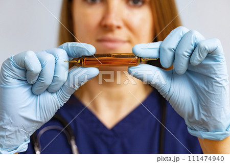 Medical Professional Examining Amber Ampoule 111474940