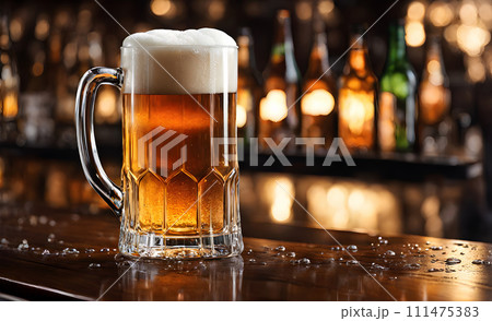 Frothy beer being poured into a chilled glass 111475383