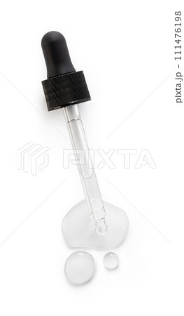 Drop falls from a pipette into a cosmetic bottle Drop falls from a pipette into a cosmetic bottle 111476198
