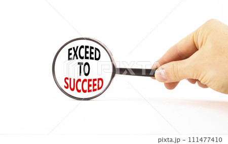 Exceed to succeed symbol. Concept words Exceed to succeed in beautiful magnifying glass. Beautiful white table white background. Businessman hand. Business and exceed to succeed concept. Copy space. 111477410