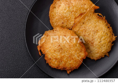 Delicious crispy pancakes made from potatoes, meat, carrots, onions 111480357