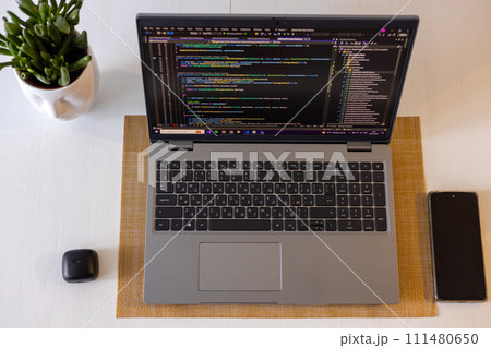 Laptop setup to work from home. Programming and coding. Phone and wireless devices. 111480650