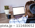 Woman with laptop, wireless technology, and indoor potted plant. 111480652