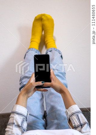 Adult Using Smartphone for Communication Indoors 111480655