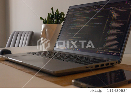 Laptop setup to work from home. Programming and coding. Phone and wireless devices. 111480684