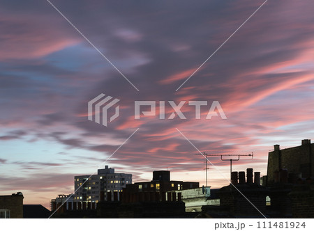 View of buildings and house during stunning beauty sunset and teal evening sky with dramatic clouds. 111481924