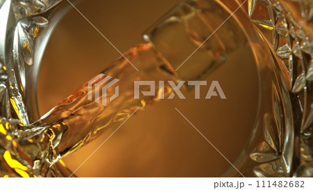 Pouring Whiskey into Glass, Macro Shot. 111482682