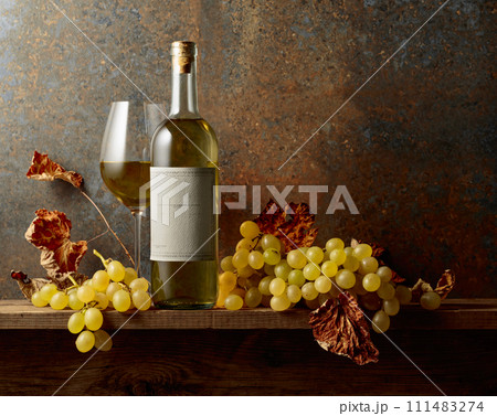 White wine with grapes and dried up vine leaves. White wine with grapes and dried up vine leaves. 111483274