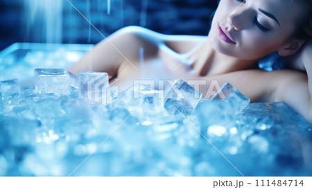Woman Relaxing in Ice bath. Serene female immersing in a bathtub filled with ice cubes. Cryotherapy for health Woman Relaxing in Ice bath. Serene female immersing in a bathtub filled with ice cubes. Cryotherapy for health 111484714