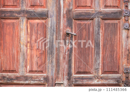 Old, vintage wooden red and pink painted doors detail with steel handle 111485366