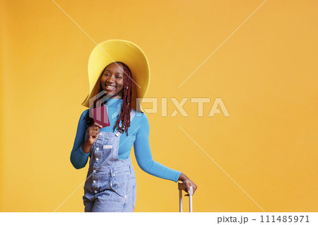 Woman travelling with id documentation on international airplane flight for vacation abroad, weekend activity. Joyful girl with passport leaving on holiday trip, leisure destination. 111485971