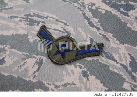 August 31, 2020. US AIR FORCE Airman rank patch on digital tiger-stripe pattern Airman Battle Uniform (ABU) background 111487539