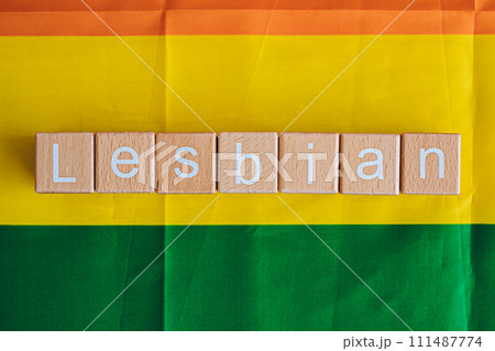 Wooden blocks form the text "Lesbian" against a rainbow background. 111487774