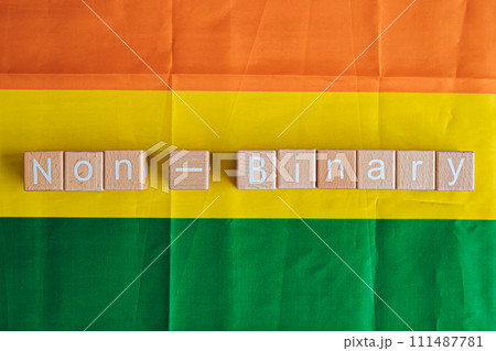 Wooden blocks form the text "Non-Binary" against a rainbow background. Wooden blocks form the text "Non-Binary" against a rainbow background. 111487781