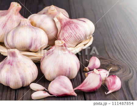 Cloves of garlic on wooden background, concept healthy lifestyle. 111487854